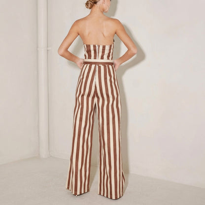 Woman in striped strapless jumpsuit, brown and white.