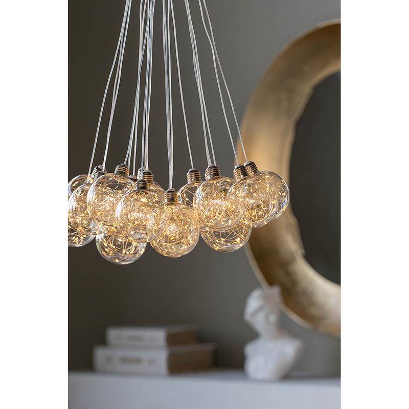 Cluster of glowing string light bulbs with a blurred background.