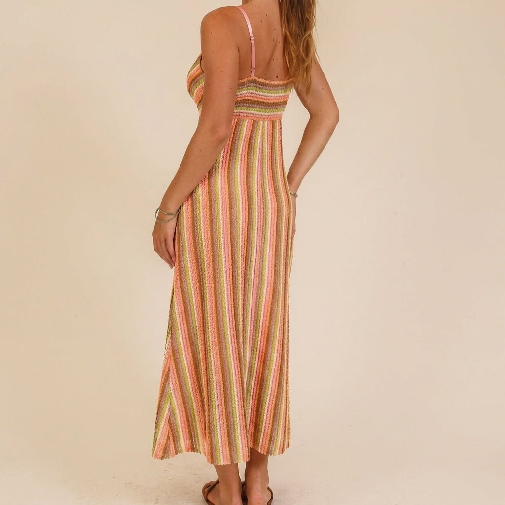 Woman in a colorful striped dress, viewed from behind.