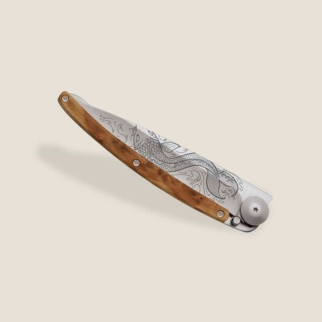 Elegant folding knife with wood handle and engraved blade.
