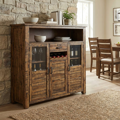 Rustic wooden sideboard with wine and glass storage near dining table.