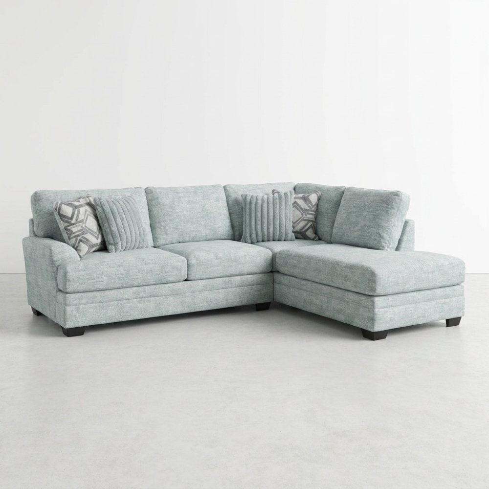 Light blue sectional sofa with patterned cushions.