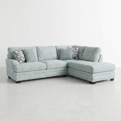 Light blue sectional sofa with patterned cushions.