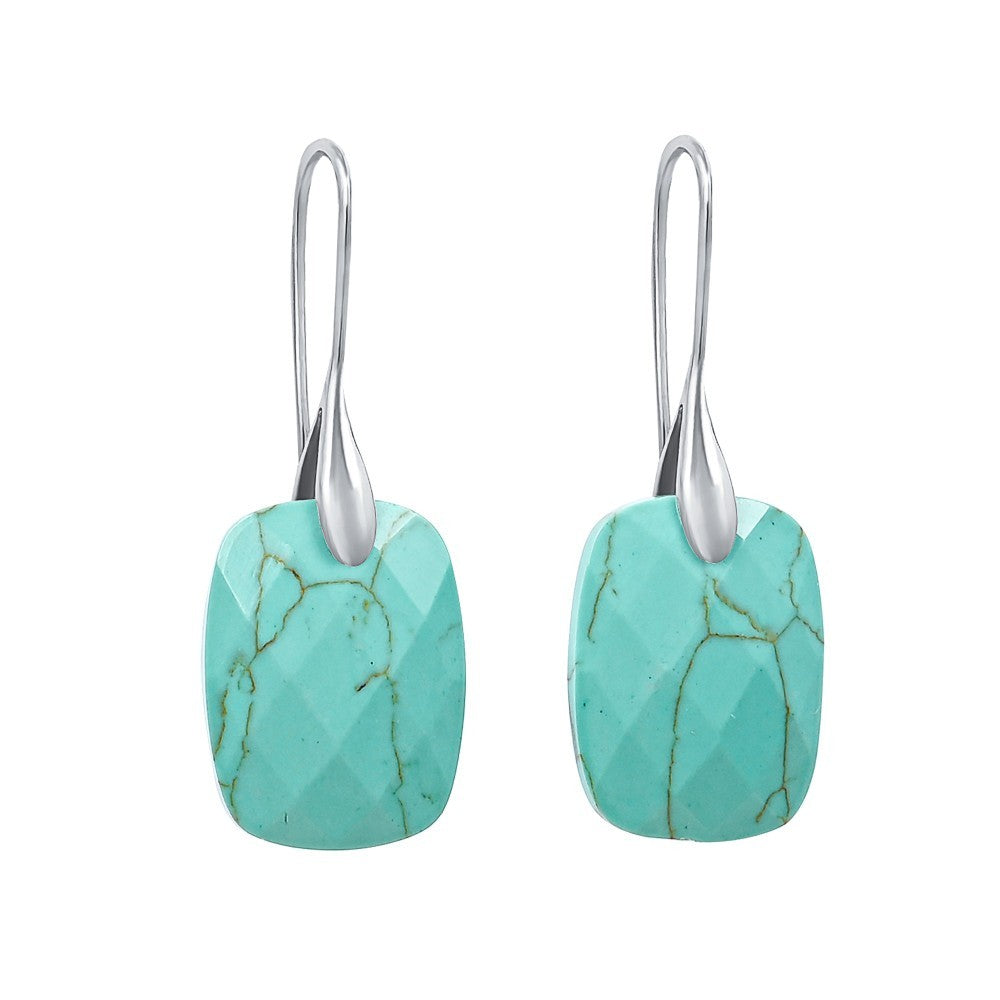 Turquoise stone earrings with silver hooks.