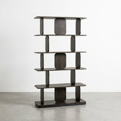 Modern dark wood bookshelf on a minimalist concrete floor.