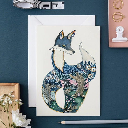 Artistic fox card with woodland design surrounded by stationery.
