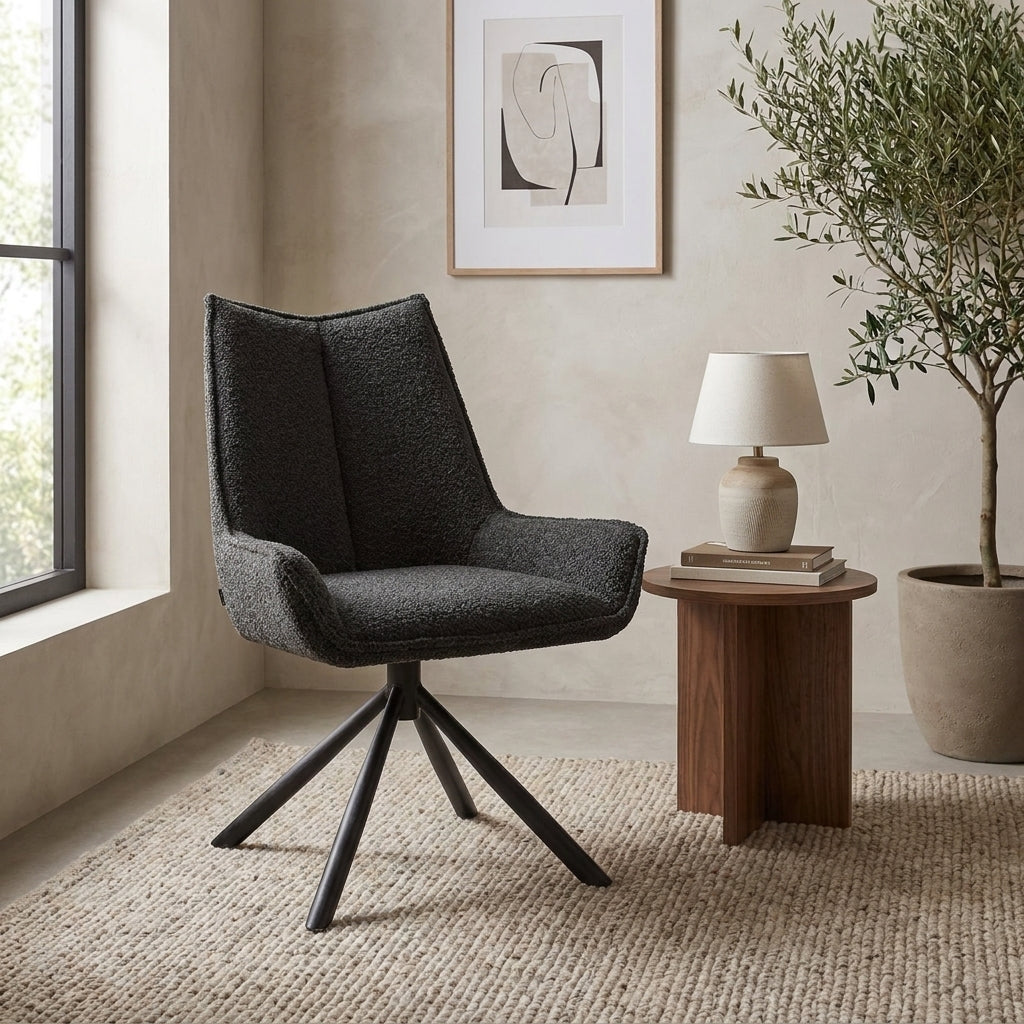 Stylish armchair in modern room with table, lamp, and artwork.