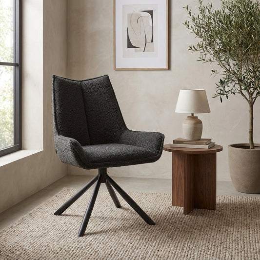 Stylish armchair in modern room with table, lamp, and artwork.