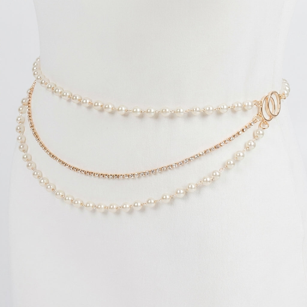 Elegant triple-layer pearl waist chain on a white mannequin.