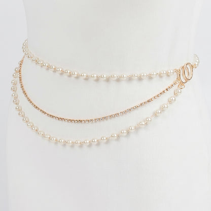 Elegant triple-layer pearl waist chain on a white mannequin.
