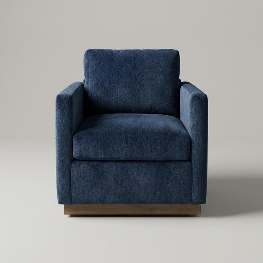 A blue fabric armchair with wooden base on a gray background.