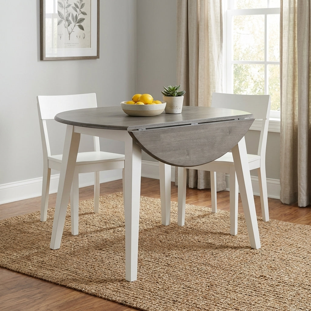 Gray drop-leaf table, white chairs, bowl of lemons, plant; bright dining area.