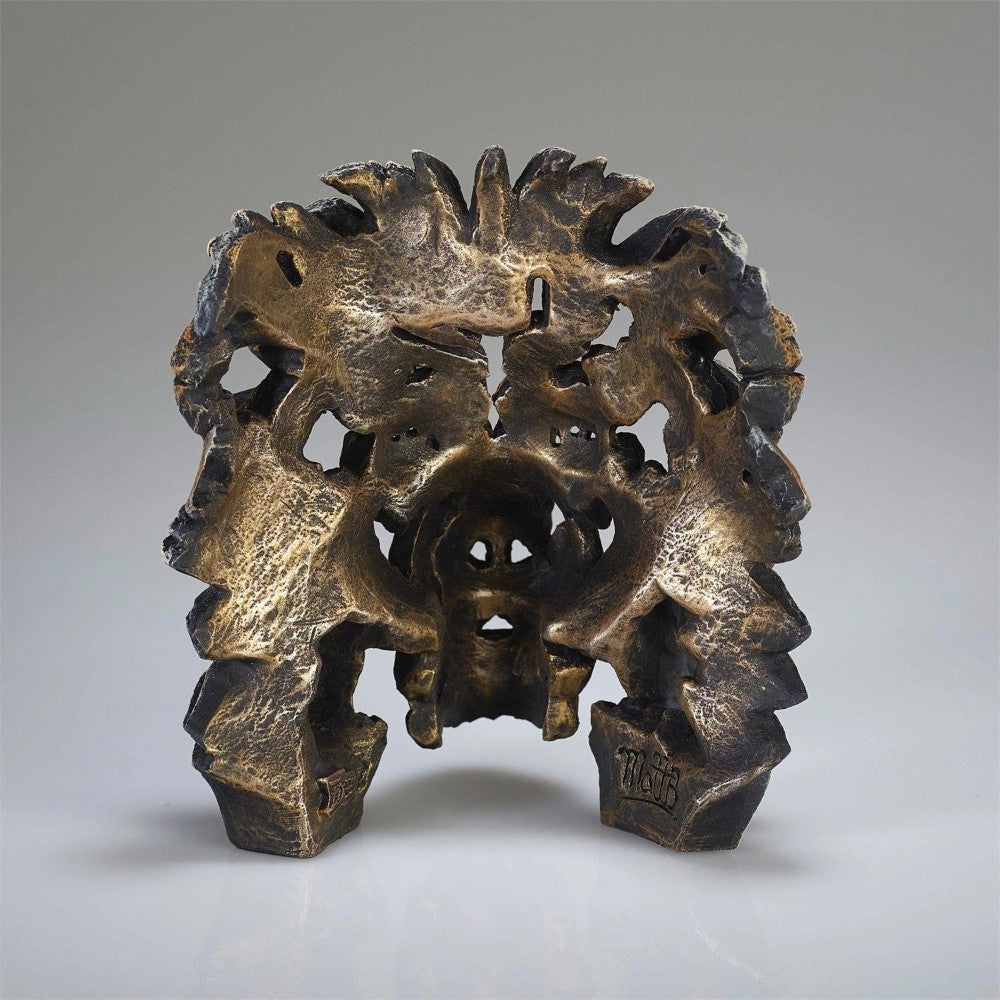 Intricate bronze sculpture with organic shapes and textures.
