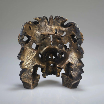 Intricate bronze sculpture with organic shapes and textures.
