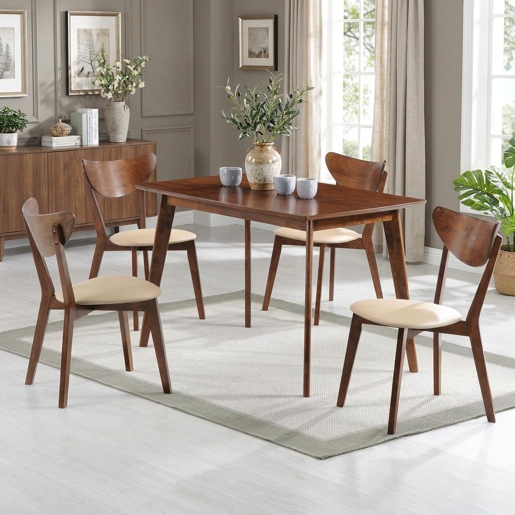 Wooden dining set with four chairs, white flowers, and gray cups on a carpeted floor.