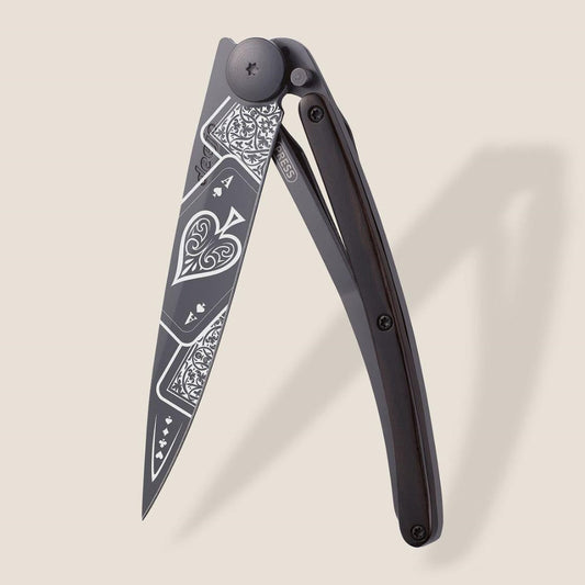 Knife with intricate playing card designs on the blade.