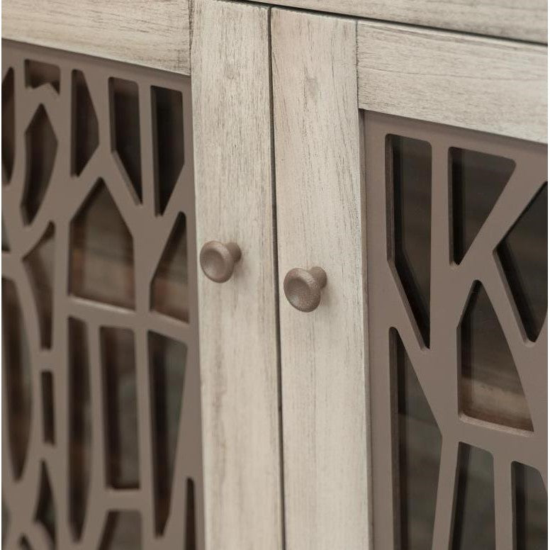 Wooden cabinet doors with decorative cut-out design and round knobs.