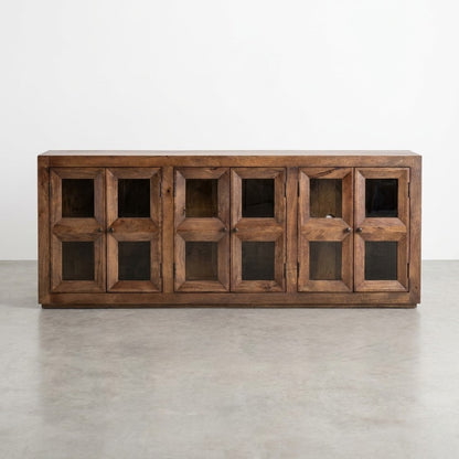 Wooden cabinet with four geometric glass doors, open to show interior shelves.