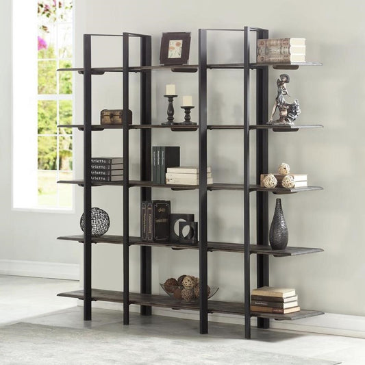 Modern shelf with books, decor, and candles by a window.