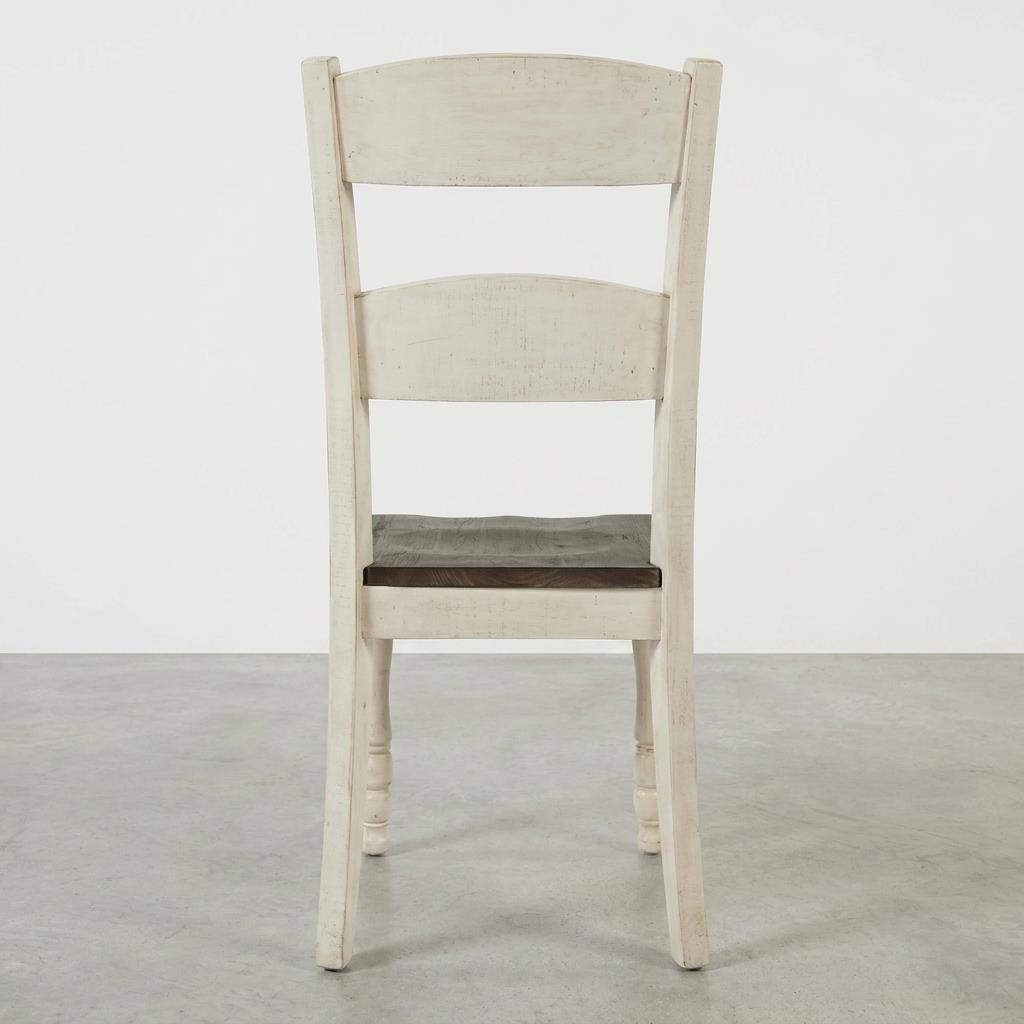 Wooden chair with a cream finish and a dark seat, viewed from the back.