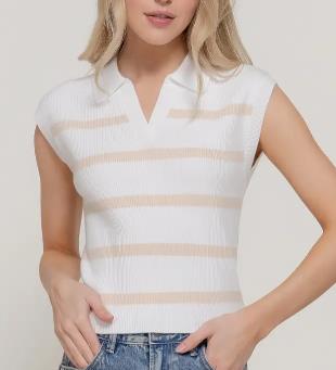 Woman in a striped sleeveless top and jeans, hands at waist.