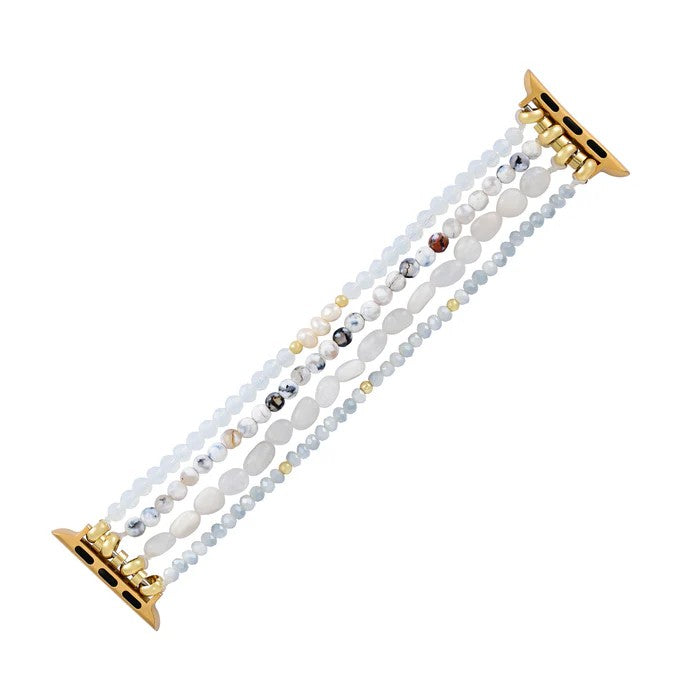 Gold connector bracelet with multicolored gemstone strands.