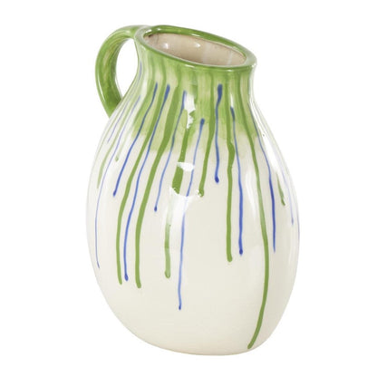 White ceramic pitcher with green and blue drips.