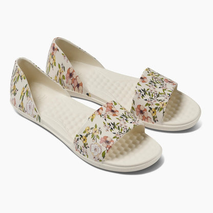 Floral slip-on sandals with open toes and cushioned soles.