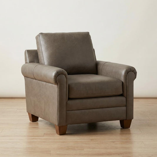 Taupe leather armchair on a wooden floor.