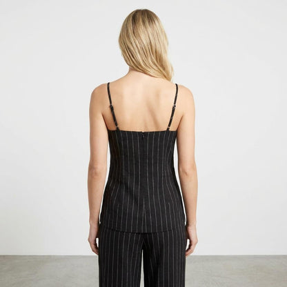 Person in pinstriped outfit, back view.