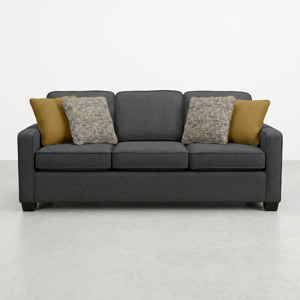 Dark gray sofa with four cushions on a light floor.