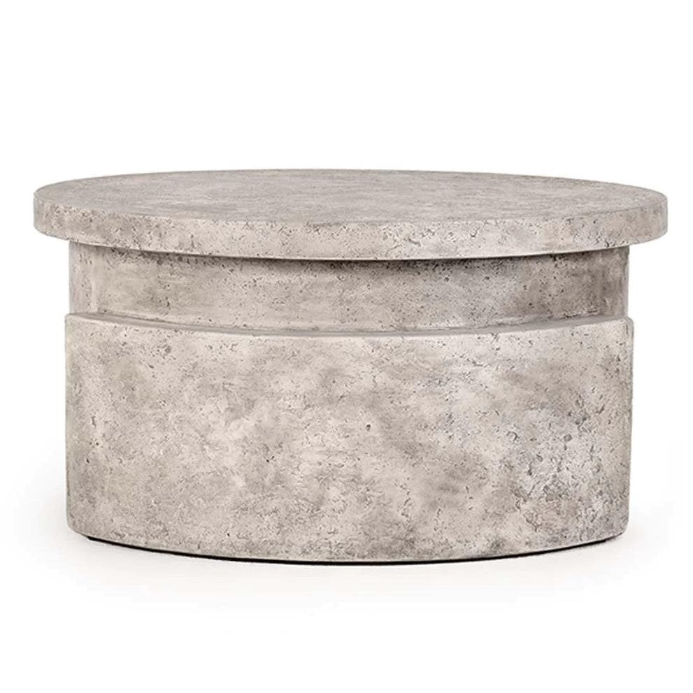 Round concrete table with a smooth surface and textured finish.