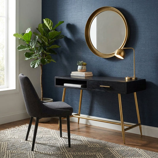 Black desk with gold legs, featuring one open shelf and a drawer.