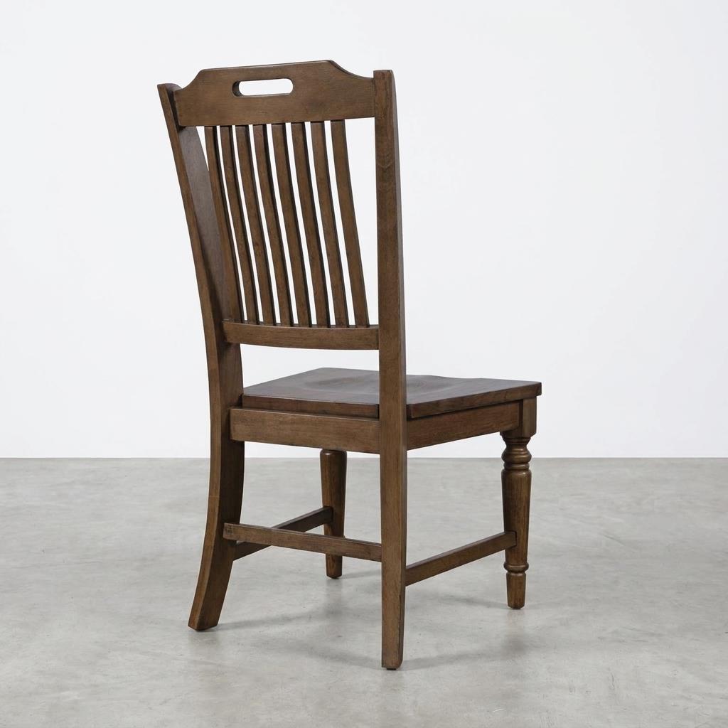 Wooden chair with slatted backrest on a gray floor.