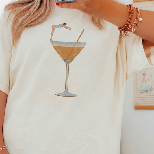 T-shirt with a person diving into a cocktail glass illustration.