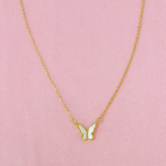 Gold chain with butterfly pendant on pink background.