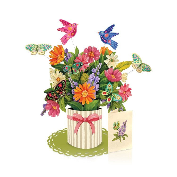 Vibrant floral arrangement with butterflies and birds in a decorative pot.