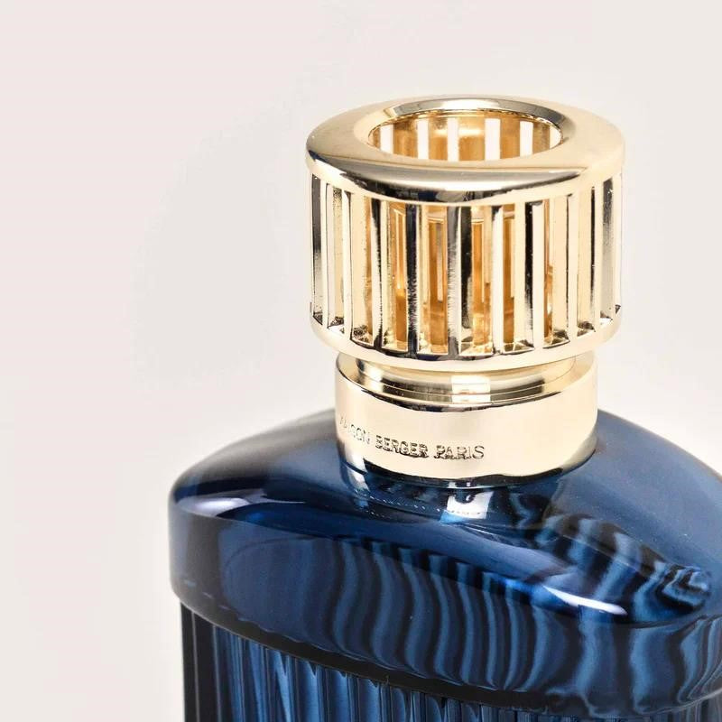 Blue bottle with a gold lattice cap, elegant design.