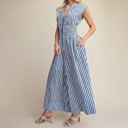 Woman in a blue-striped jumpsuit with heels.