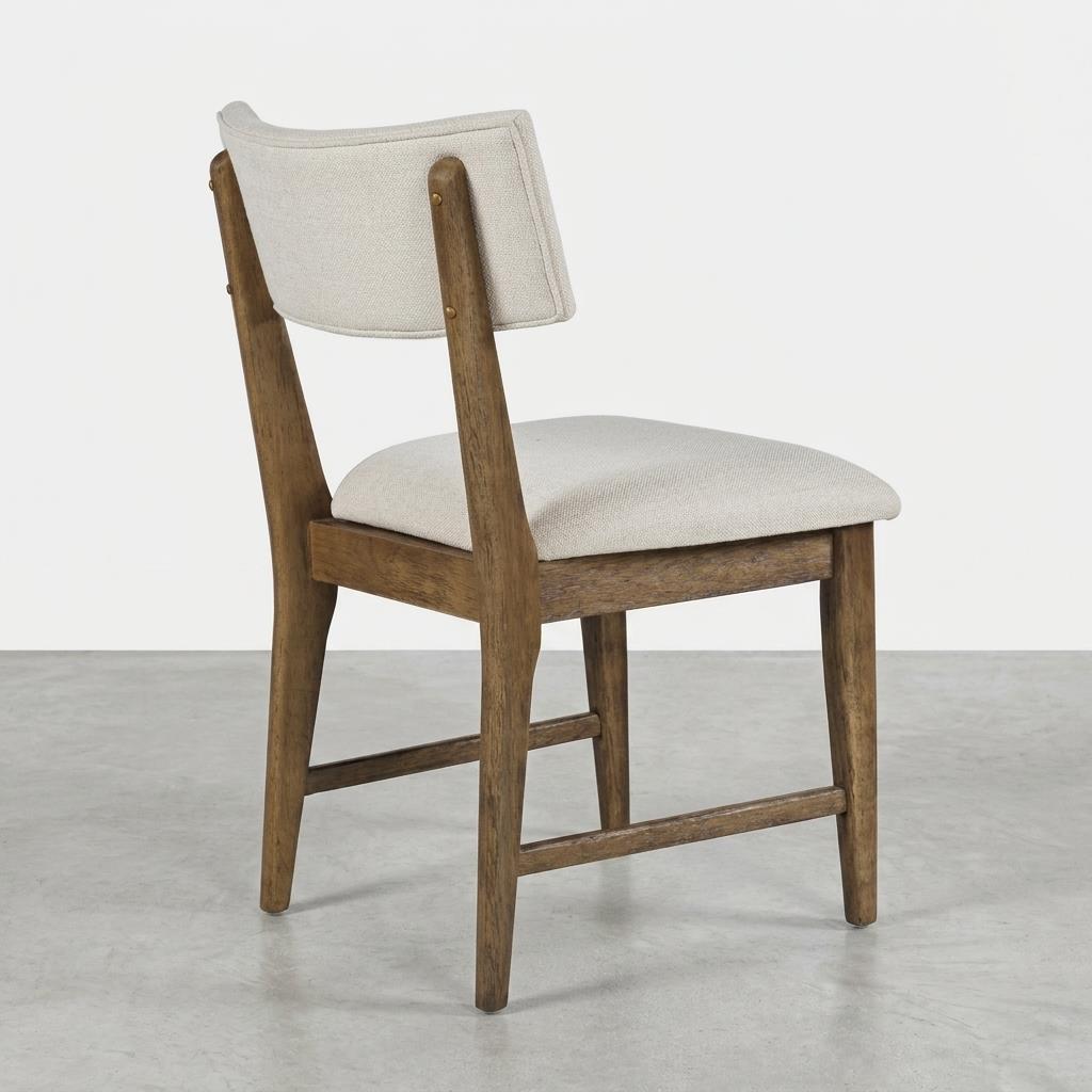 Wooden chair with white cushioned seat and backrest, angled view.
