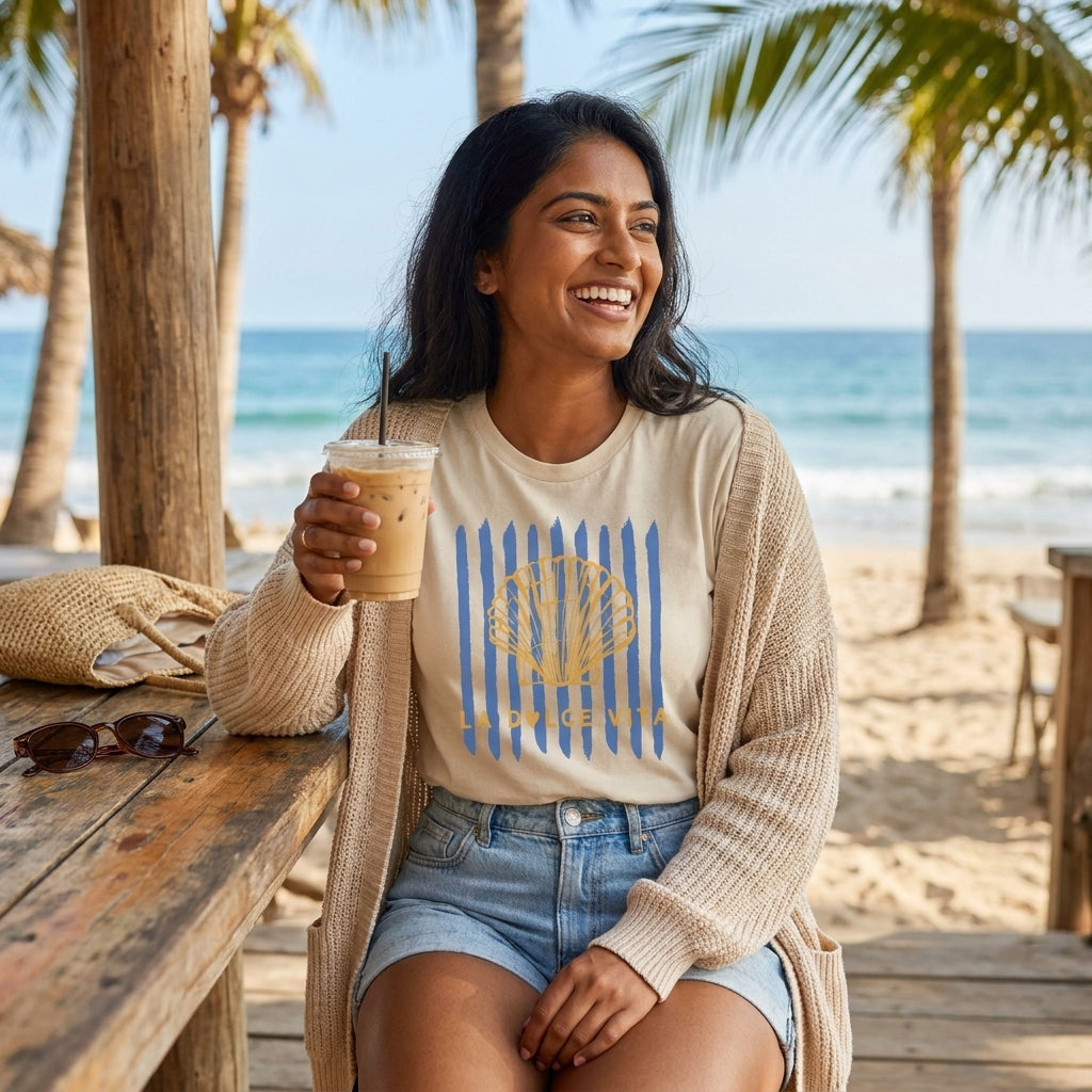 Smiling woman enjoying iced coffee at a beachside table under palm trees.