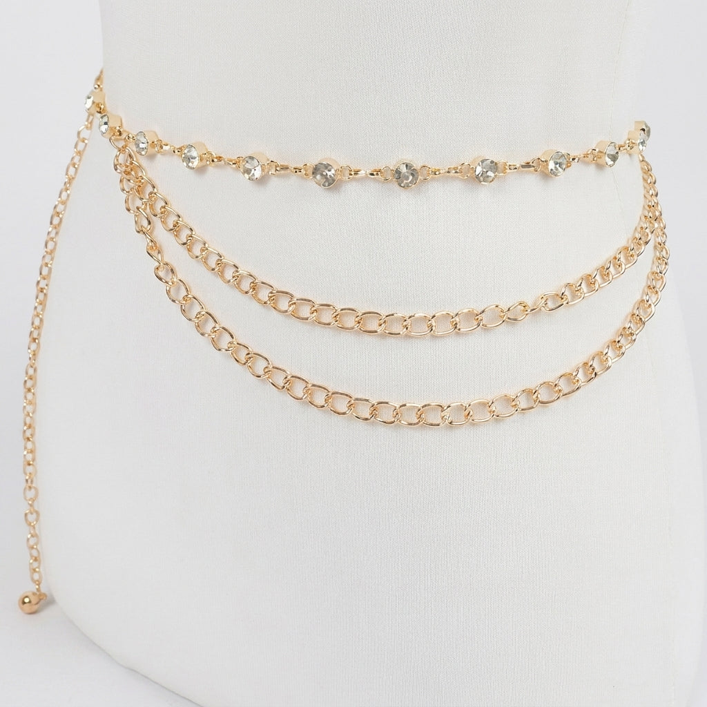 Gold chain belt with rhinestone accents on a white mannequin.