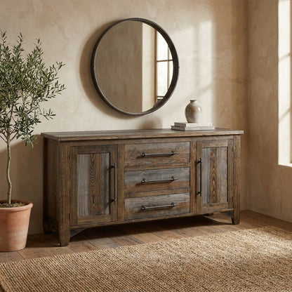 Rustic wooden dresser with round mirror and decorative vase.