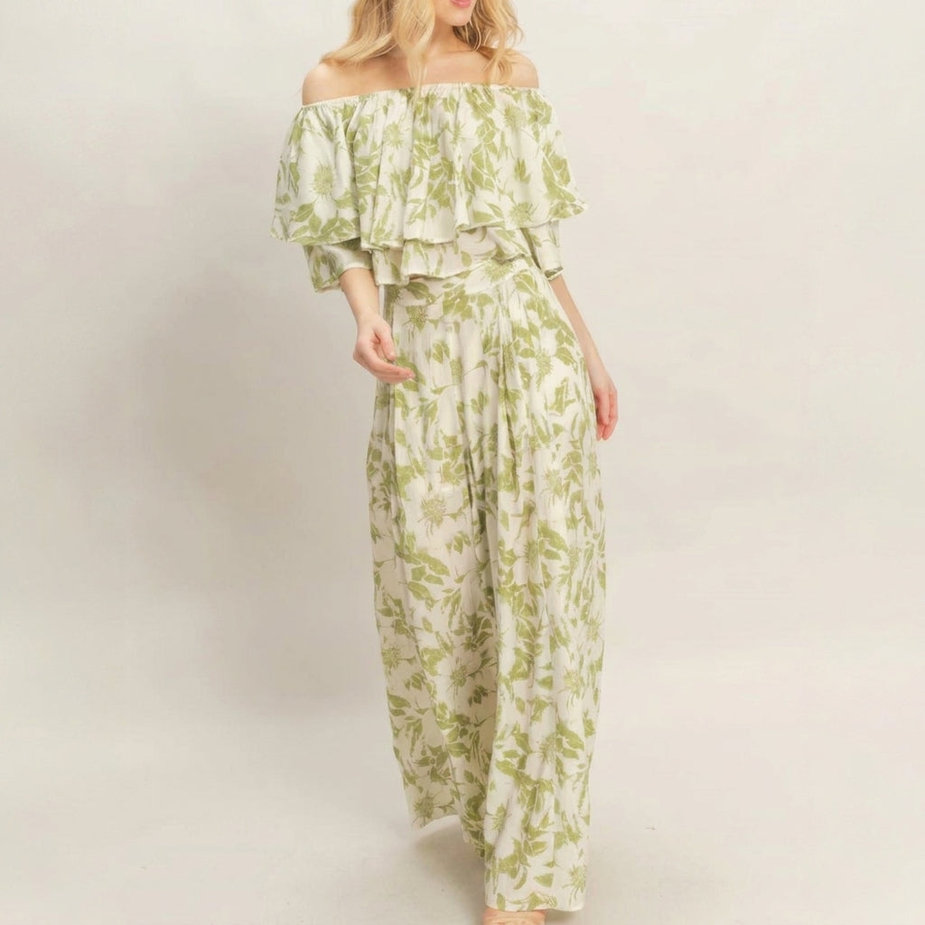Woman in a floral off-shoulder outfit against a plain background.