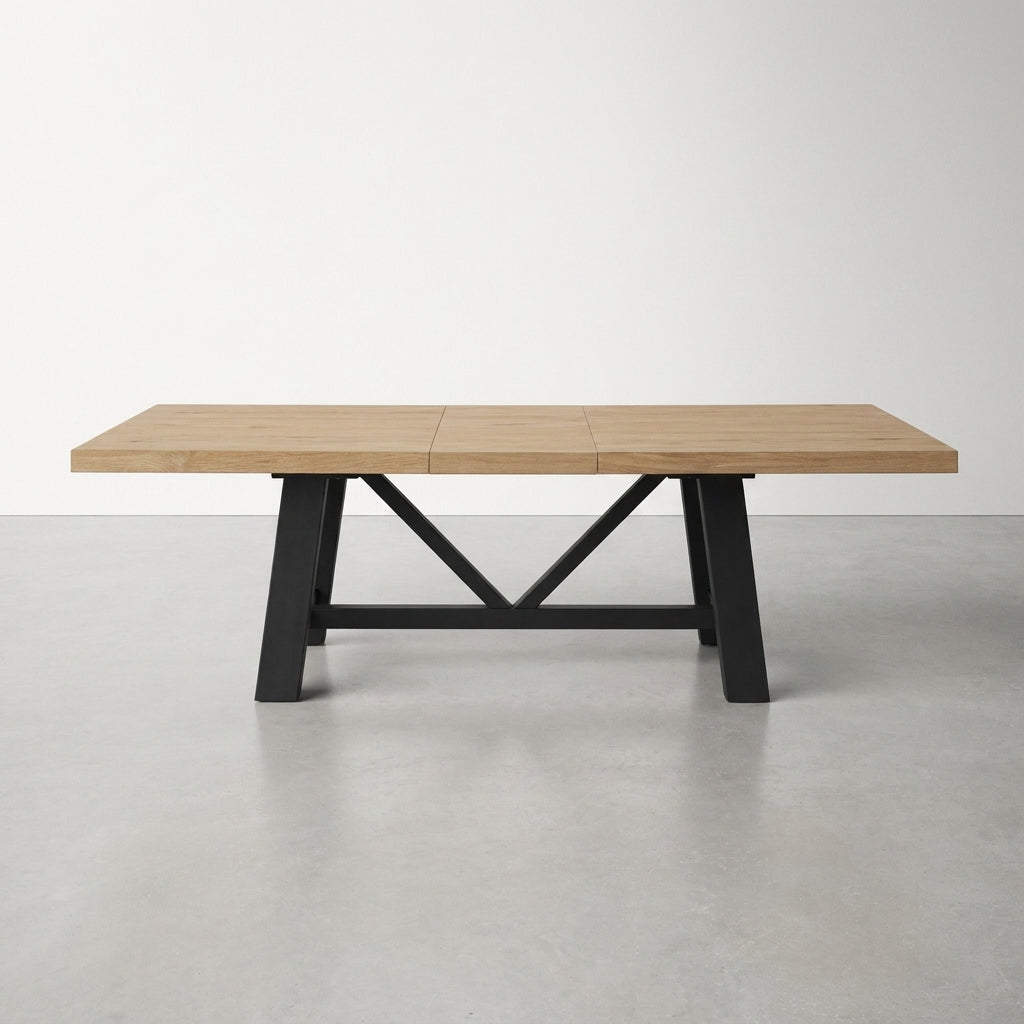 Wooden table with black metal legs featuring a cross support.