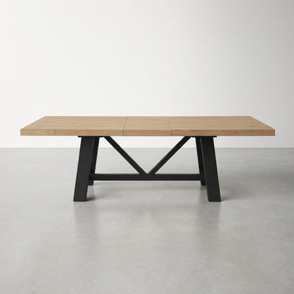 Wooden table with black metal legs featuring a cross support.