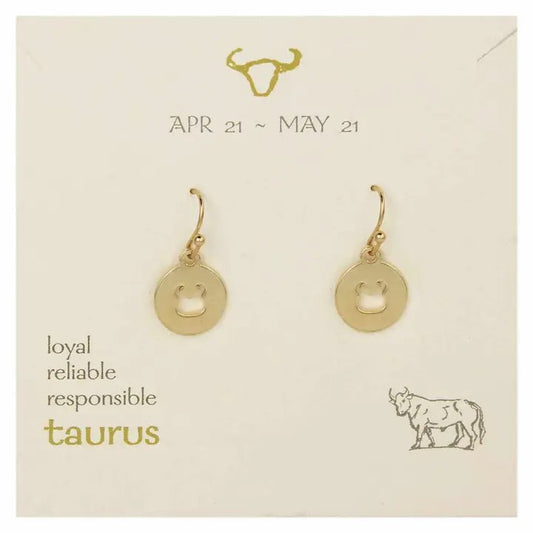 Gold Taurus earrings with a bull motif on a card listing April 21-May 21 dates.