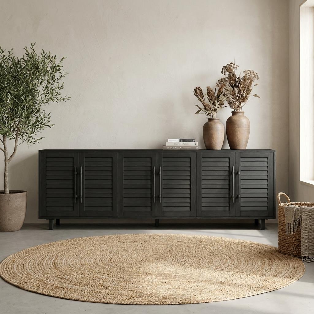 A dark wooden sideboard with vases and plants in a calm, neutral living room.