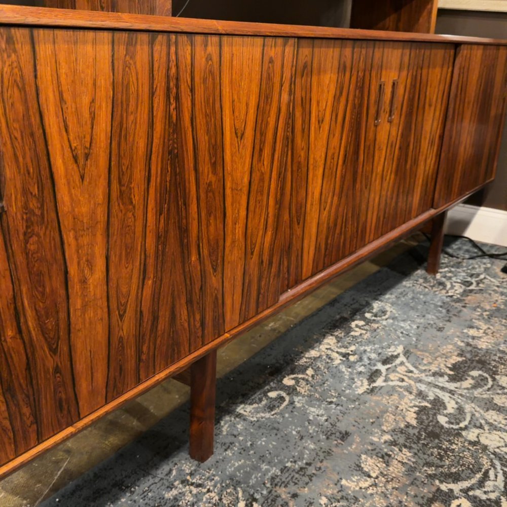 Wooden cabinet with rich grain pattern on a patterned rug.