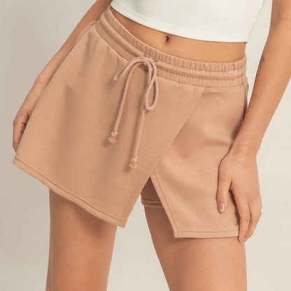 Tan wrap skirt with tie waist, worn with a white top.